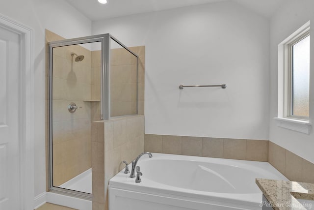 full bathroom with a stall shower, a wealth of natural light, vanity, and a bath