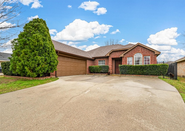 single story home featuring an attached garage, roof with shingles, concrete driveway, and brick siding