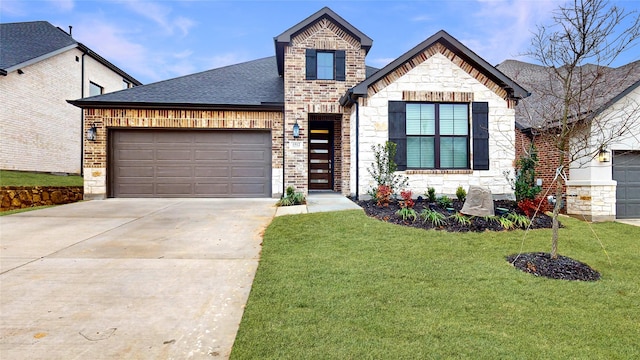 french country inspired facade featuring a garage, driveway, a shingled roof, and a front lawn