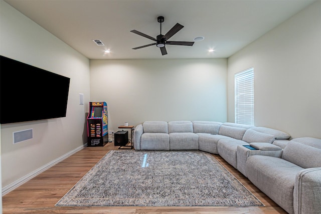 living room with baseboards, visible vents, a ceiling fan, light wood-style floors, and recessed lighting