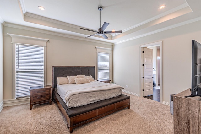 carpeted bedroom featuring baseboards, a raised ceiling, crown molding, and recessed lighting