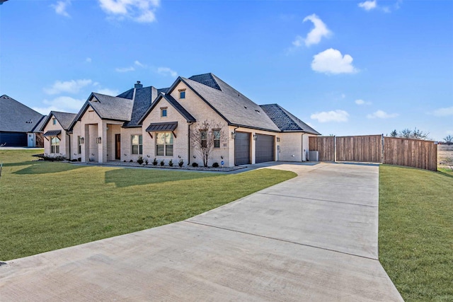 french country home featuring a garage, a chimney, a front yard, and fence