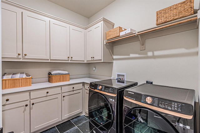 washroom featuring washing machine and dryer and cabinet space