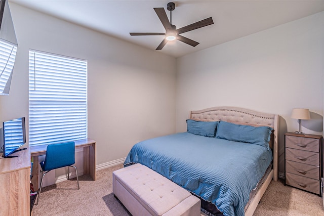 carpeted bedroom featuring ceiling fan and baseboards