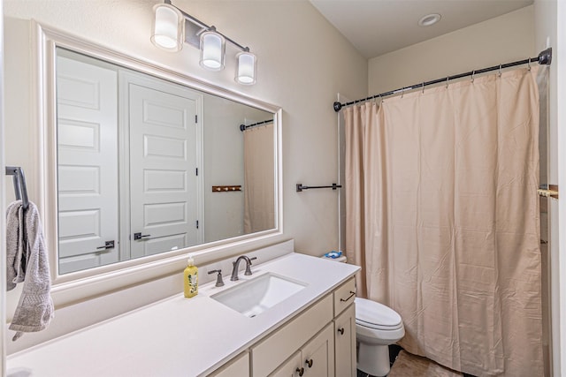 full bathroom with toilet and vanity