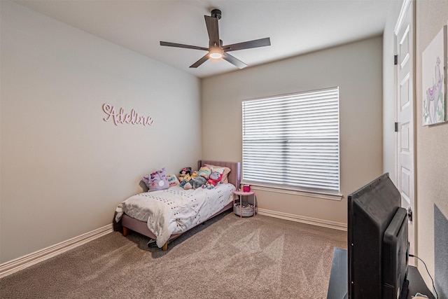 carpeted bedroom featuring a ceiling fan and baseboards