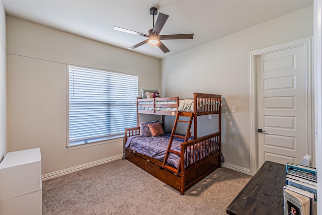 bedroom with light carpet, baseboards, and a ceiling fan