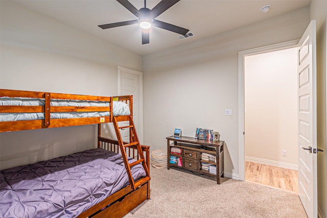 bedroom featuring baseboards, visible vents, and light colored carpet