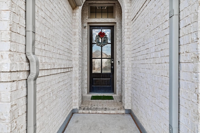 property entrance with brick siding