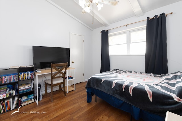 bedroom with lofted ceiling with beams and wood finished floors