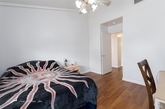 bedroom with baseboards and dark wood-type flooring