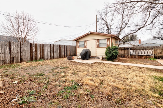 rear view of house with a patio area and a fenced backyard