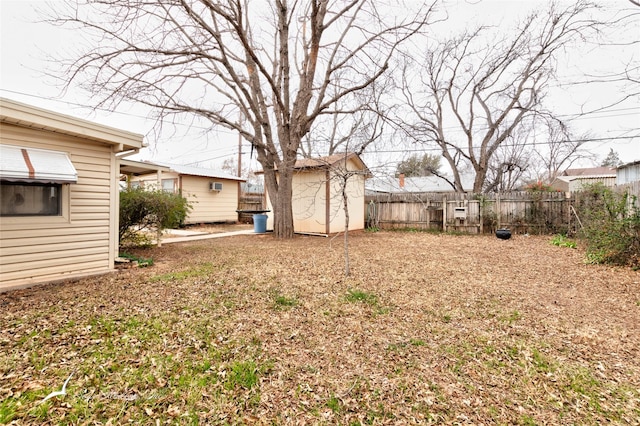 view of yard with an outdoor structure, a storage shed, and fence