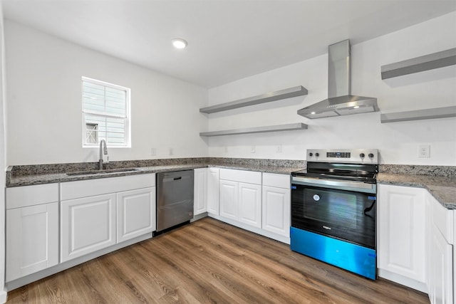 kitchen with open shelves, stainless steel appliances, white cabinets, a sink, and wall chimney range hood