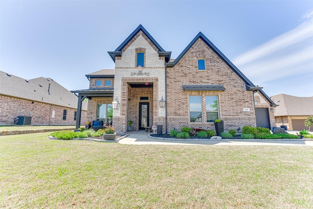 326 Prairie View Rd, Rockwall, TX 75087 - french provincial home featuring brick siding, cooling unit, and a front lawn