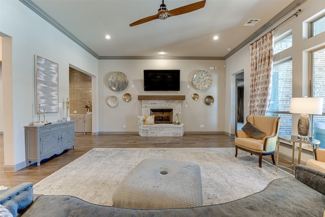 326 Prairie View Rd, Rockwall, TX 75087 - living area featuring crown molding, visible vents, ceiling fan, and a fireplace