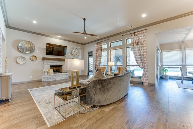 326 Prairie View Rd, Rockwall, TX 75087 - living area with crown molding, visible vents, a ceiling fan, and a stone fireplace