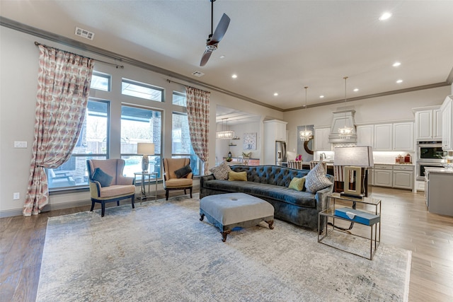 326 Prairie View Rd, Rockwall, TX 75087 - living room featuring recessed lighting, visible vents, ceiling fan with notable chandelier, and ornamental molding