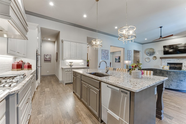 326 Prairie View Rd, Rockwall, TX 75087 - kitchen featuring custom range hood, a stone fireplace, open floor plan, appliances with stainless steel finishes, and a sink