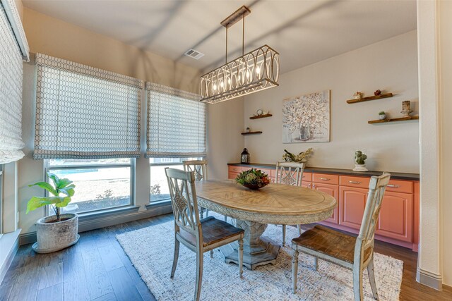 326 Prairie View Rd, Rockwall, TX 75087 - dining room with wood finished floors, an inviting chandelier, and visible vents