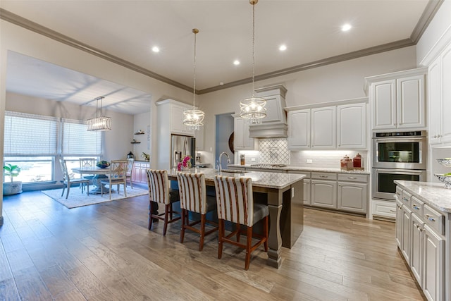 326 Prairie View Rd, Rockwall, TX 75087 - kitchen featuring an island with sink, appliances with stainless steel finishes, a sink, decorative backsplash, and a breakfast bar area