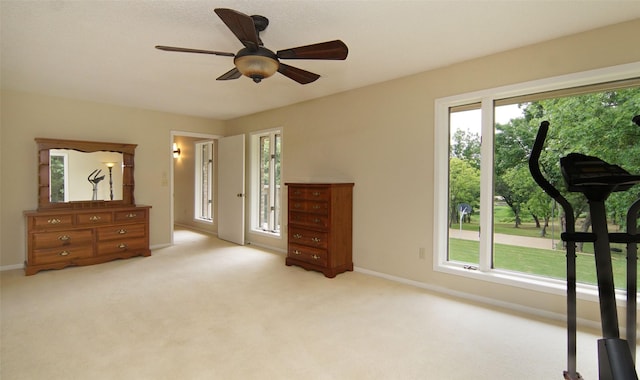 bedroom with baseboards, a ceiling fan, and light colored carpet