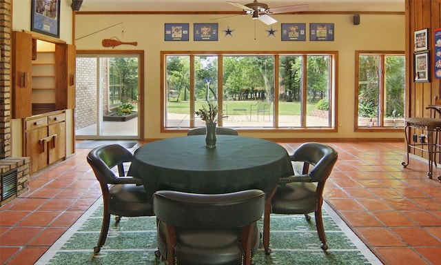 dining room with a ceiling fan and tile patterned floors