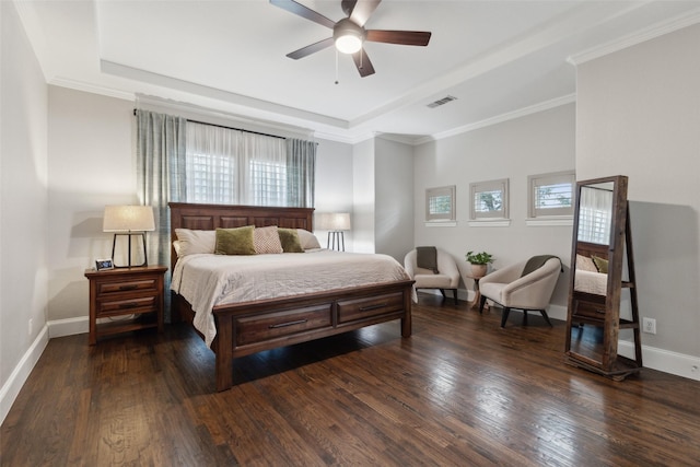 bedroom featuring dark wood-type flooring, a raised ceiling, visible vents, and baseboards