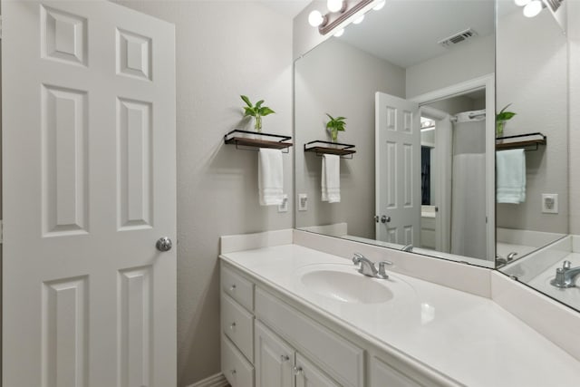 bathroom featuring visible vents and vanity