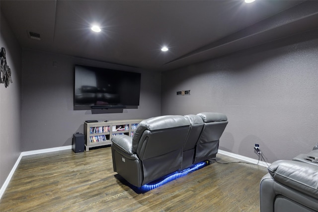 home theater room featuring dark wood-style floors, baseboards, visible vents, and recessed lighting