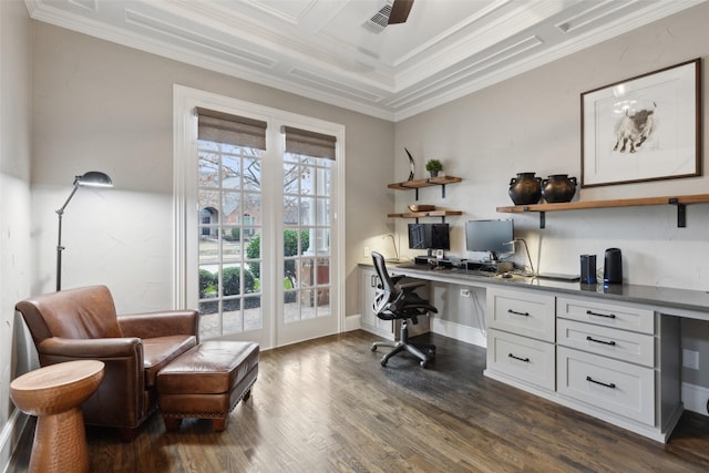 office space featuring built in desk, dark wood finished floors, visible vents, and crown molding