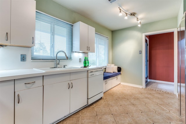 430 Mayrant Dr, Dallas, TX 75224 - kitchen with dishwasher, a sink, light countertops, white cabinets, and plenty of natural light