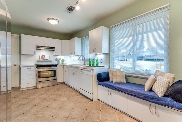 430 Mayrant Dr, Dallas, TX 75224 - kitchen featuring stainless steel range with electric stovetop, a sink, under cabinet range hood, and plenty of natural light
