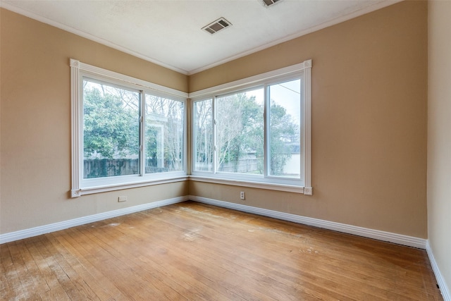 430 Mayrant Dr, Dallas, TX 75224 - spare room with crown molding, healthy amount of natural light, baseboards, and light wood finished floors