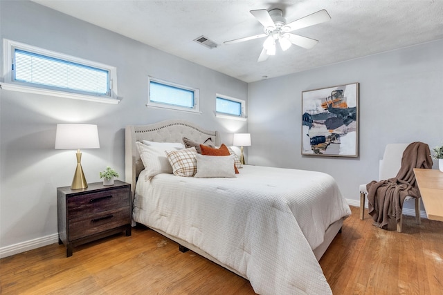 430 Mayrant Dr, Dallas, TX 75224 - bedroom with light wood-style floors, baseboards, and a ceiling fan