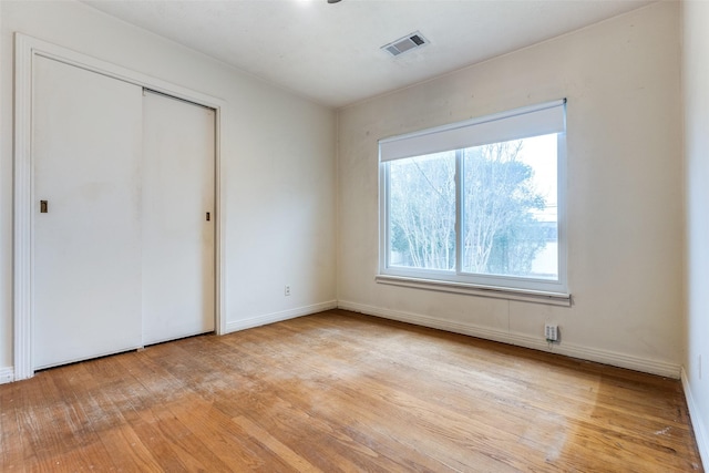 430 Mayrant Dr, Dallas, TX 75224 - unfurnished bedroom featuring light wood-style floors, a closet, and baseboards