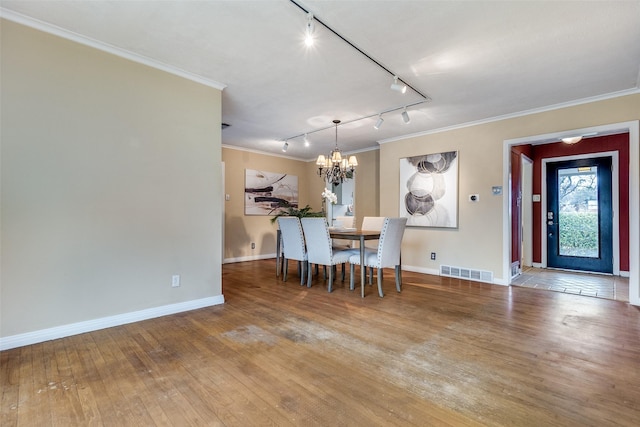 430 Mayrant Dr, Dallas, TX 75224 - dining room featuring track lighting, a chandelier, ornamental molding, wood-type flooring, and baseboards