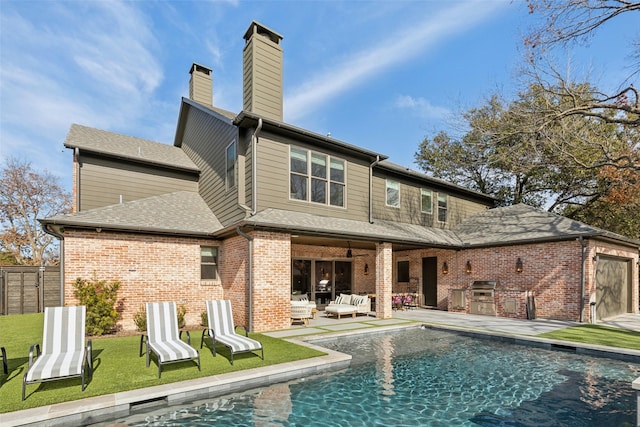 back of property with an outdoor kitchen, a patio area, an outdoor living space, and brick siding