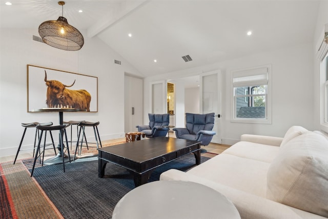 living area with light wood finished floors, baseboards, visible vents, and beamed ceiling