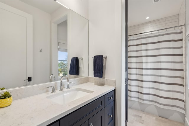 full bath with curtained shower and vanity