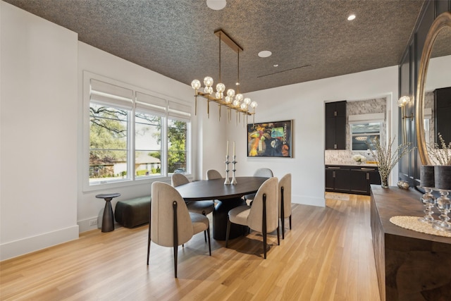 dining room with light wood-style floors and baseboards