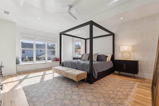 bedroom featuring baseboards, visible vents, wood finished floors, and recessed lighting