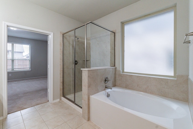 full bathroom with tile patterned flooring, a garden tub, and a shower stall