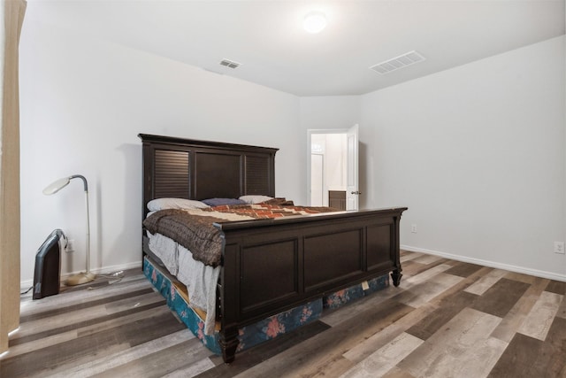 bedroom with dark wood-type flooring, visible vents, and baseboards