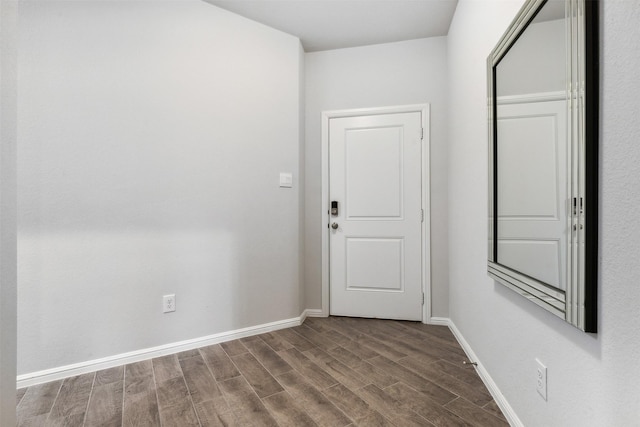 interior space with baseboards and wood finished floors