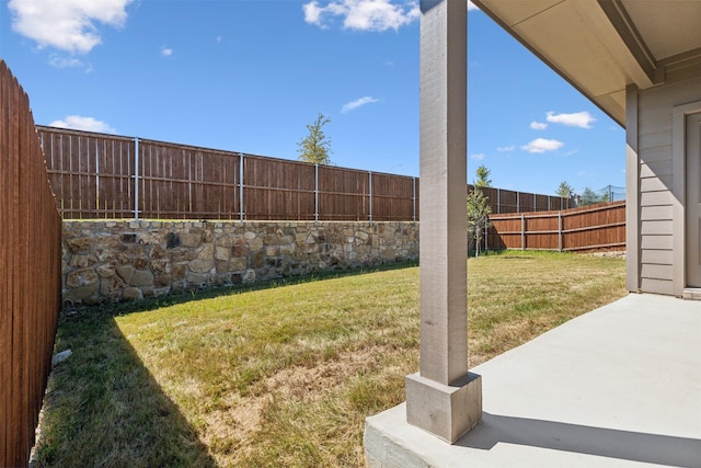 view of yard featuring a patio area and a fenced backyard