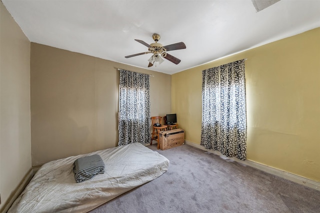 bedroom with carpet, baseboards, and a ceiling fan