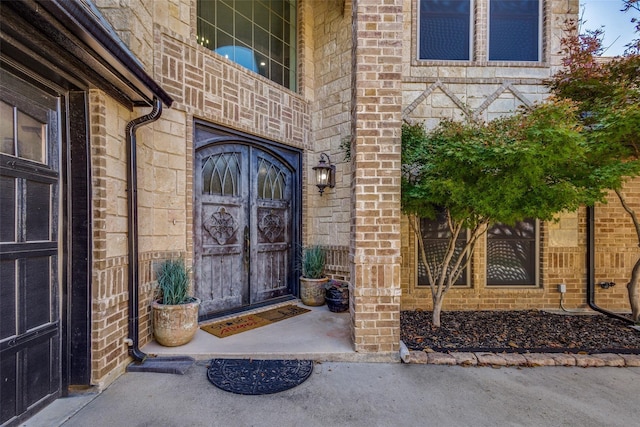 entrance to property featuring brick siding