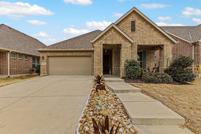 view of front of house featuring concrete driveway, brick siding, roof with shingles, and a garage