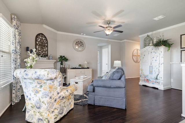 living area featuring baseboards, visible vents, dark wood finished floors, and crown molding